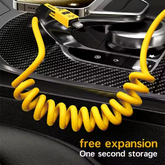 Coiled yellow data cable placed in car for easy cable management and fast charging